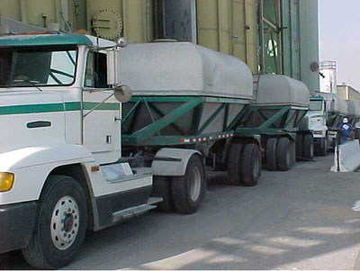 Dalton covered dome hopper trailers, setting in place to unload product into a gizzly